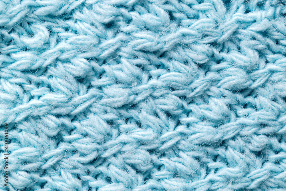 Texture of blue color, knitted sweater, close-up. Warm fabric, woolen