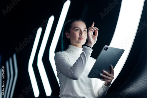 Asian girl pressing on digital screen futuristic technology