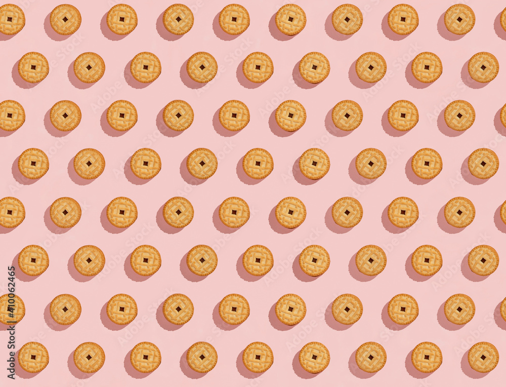 Biscuits stuffed with cream on a bright pink background, a recurring seamless pattern, sweet background, wallpaper. Copy space, banner. top view Biscuits stuffed with cream on a bright pink background, a recurring seamless pattern, sweet background, wallpaper. Copy space, banner. top view