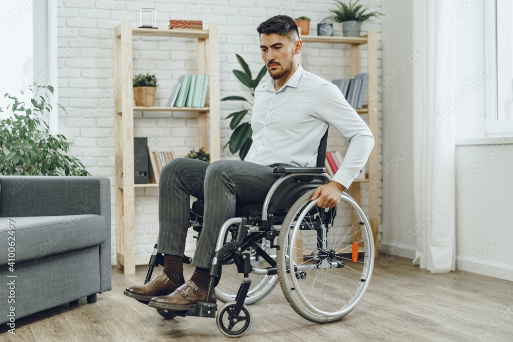 Portrait of disabled man in formal wear sitting in a wheelchair Portrait of disabled man in formal wear sitting in a wheelchair
