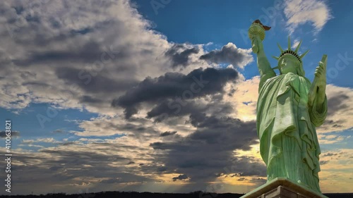 Amazing sunset with endless colorful horizon in the Statue of Liberty on New York blue perfect sky of clouds