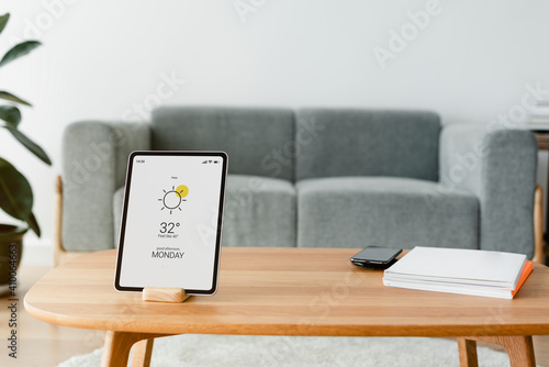 Digital tablet screen with smart home controller on a wooden table