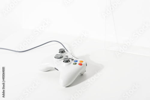 White gaming controller on white floor