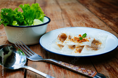 Selective focus of Thai steamed rice-skin dumplings or khao kriap pak maw is tow popular and unique Thai street food snacks ,
thai style dessert on wooden photo