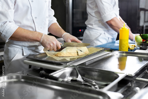 Chefs prepare meals in the kitchen