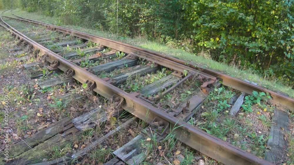 Manual railway arrow on a rusty rail track railway arrow on rusty abandoned rail track with rotten wooden sleepers in woodland bushland. Concept of crisis and destruction. Natural force of nature Manual railway arrow on a rusty rail track railway arrow on rusty abandoned rail track with rotten wooden sleepers in woodland bushland. Concept of crisis and destruction. Natural force of nature
