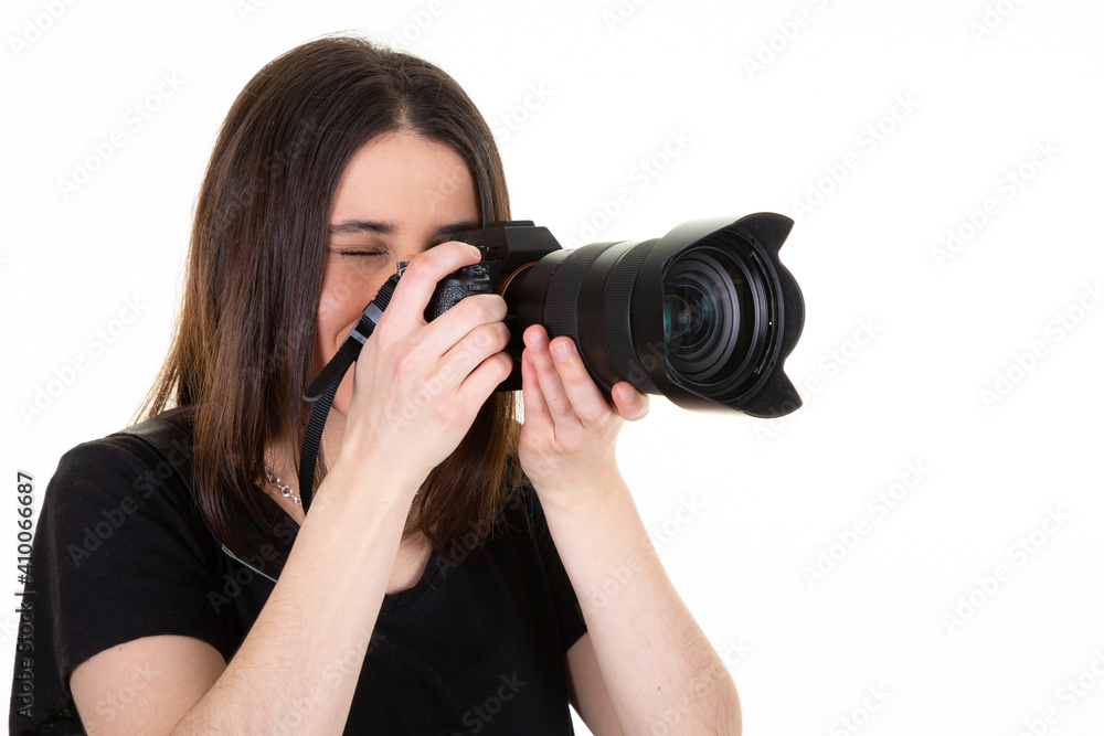 Young brunette woman over isolated white background hold black professional camera Young brunette woman over isolated white background hold black professional camera