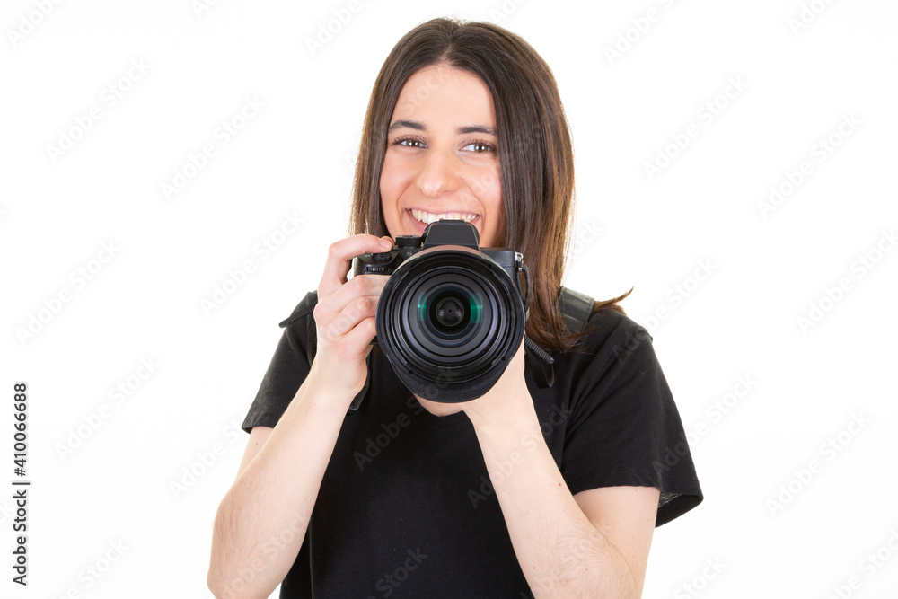 Young woman with black professional digital SLR camera over white background Young woman with black professional digital SLR camera over white background