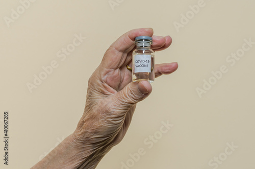 Covid-19 vaccine in the hand of an elderly woman 