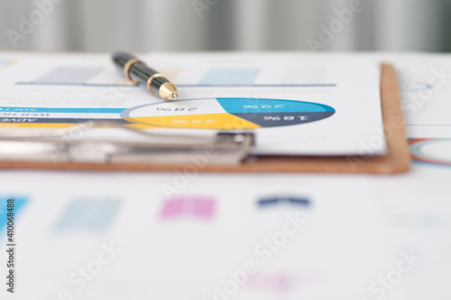 Close up of signature pen on financial materials