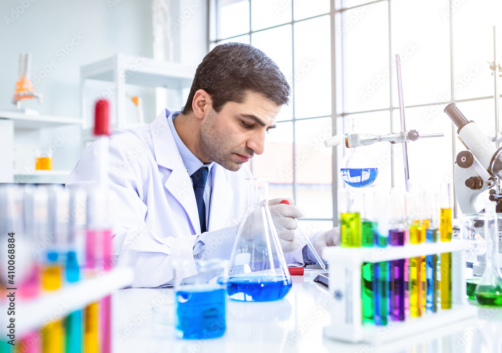 Two scientists are working holding looking at test tube with sample in a chemistry lab scientist or young female and male researcher are doing investigations in Laboratory analysis background Two scientists are working holding looking at test tube with sample in a chemistry lab scientist or young female and male researcher are doing investigations in Laboratory analysis background