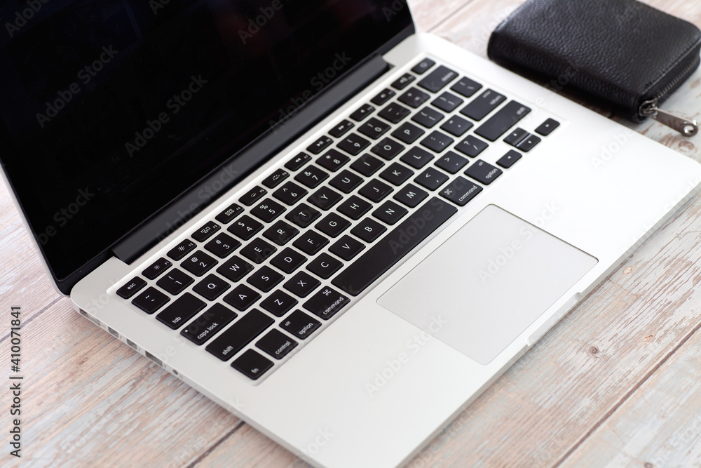 Look down at the laptop and black card bag on the desk Look down at the laptop and black card bag on the desk