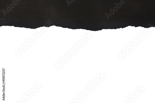 Black torn paper isolated on white background close-up.