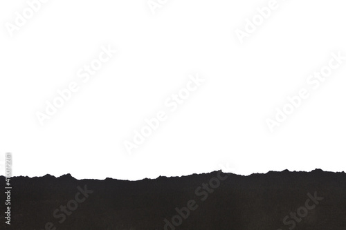 Black torn paper isolated on white background close-up.