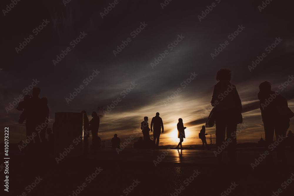 sunset silhouettes of the people at the roof  
