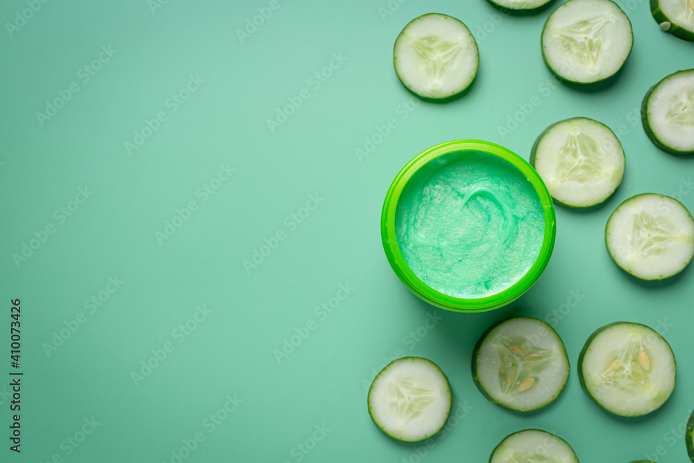 face mask with cucumber slices on light green background face mask with cucumber slices on light green background