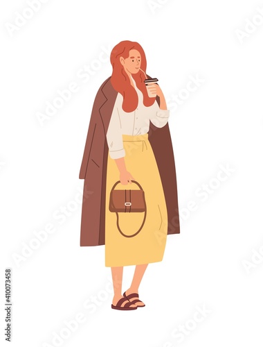 Modern young woman drinking morning coffee from paper cup on the go to wake u...