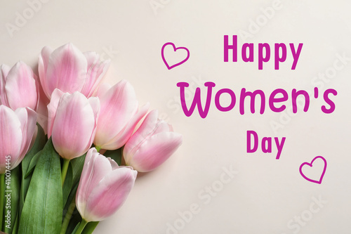 Beautiful tulips on light background, top view. Happy Women's Day