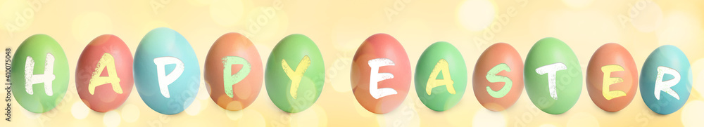 Fototapeta premium Happy Easter. Colorful dyed eggs on yellow background, banner design