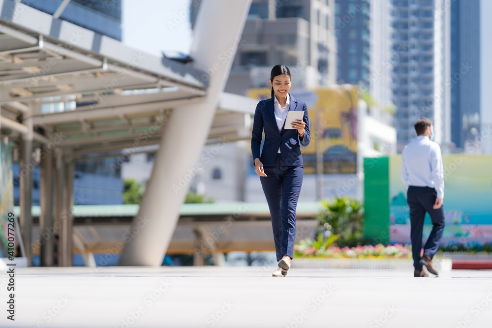 Portrait of smiling business woman holding a digital tablet