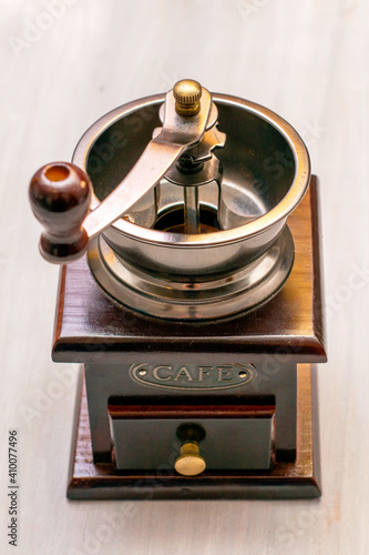 vintage handmade wooden coffee grinder stands on the table