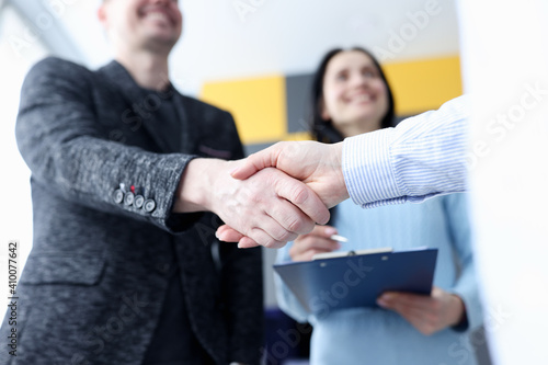 Closeup of business partners handshake in office photo