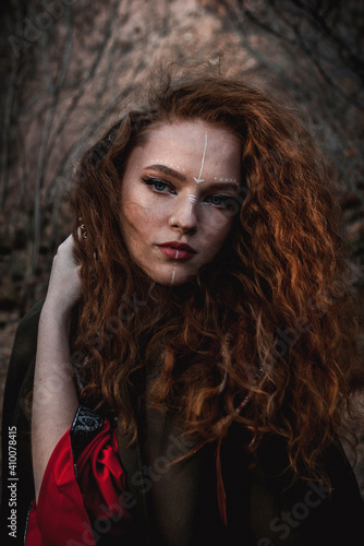 Cuadro en lienzo Red-haired woman in a red dress in a historical Celtic costume in the autumn for