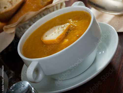 Plate of low calorie pumpkin and carrot puree served with cheese and herbs