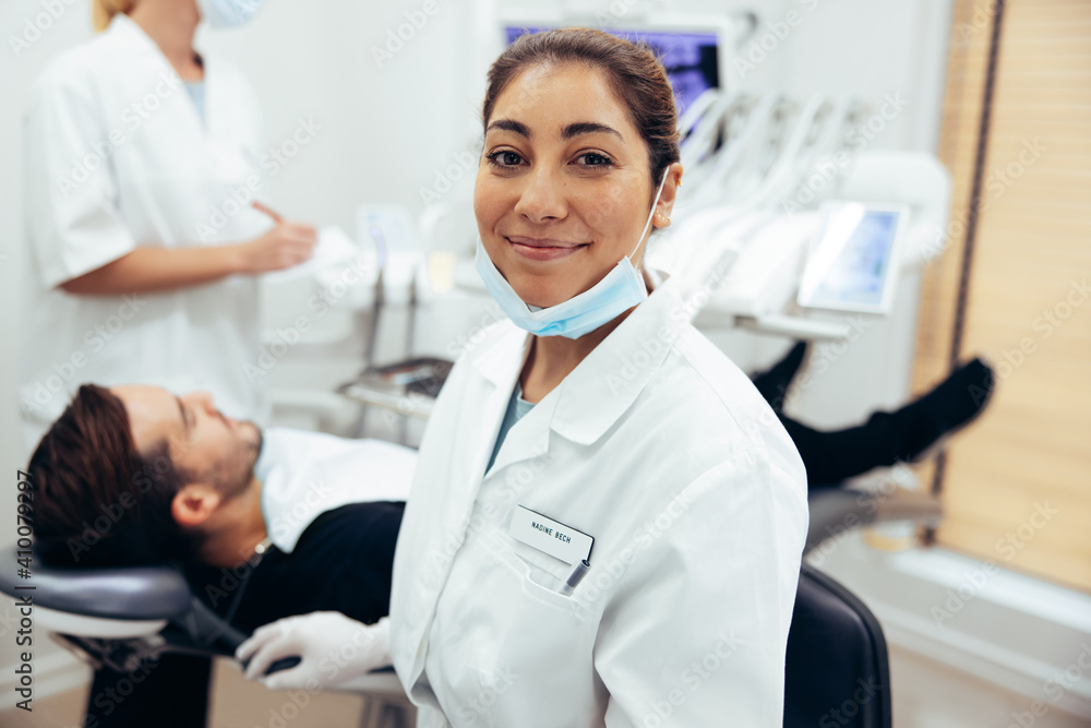 Happy female dentist in her clinic Happy female dentist in her clinic