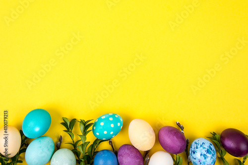 Colorful background with Easter eggs on yellow background. Happy Easter concept. Can be used as poster, background, holiday card