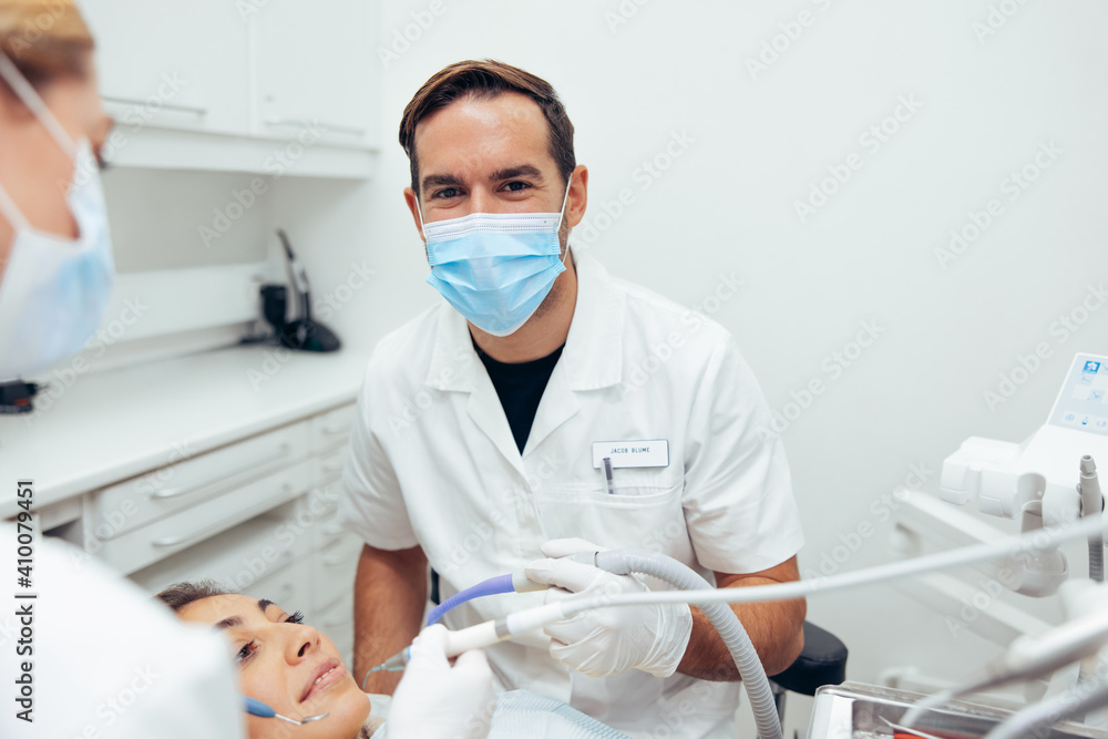 Successful dentist working on patient's teeth Successful dentist working on patient's teeth
