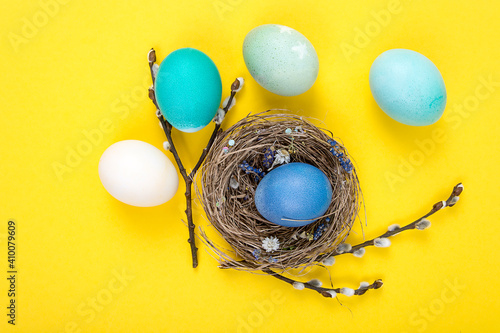 Colorful background with Easter eggs on yellow background. Happy Easter concept. Can be used as poster, background, holiday card photo