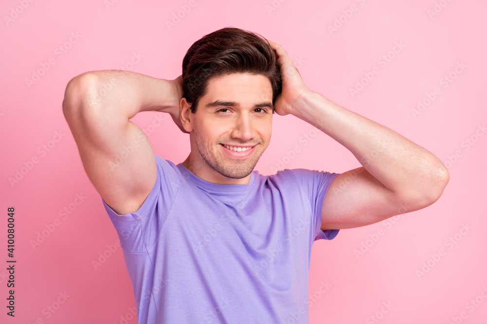 Portrait of attractive cheerful well-groomed guy touching coiffure isolated over pink pastel color background Portrait of attractive cheerful well-groomed guy touching coiffure isolated over pink pastel color background