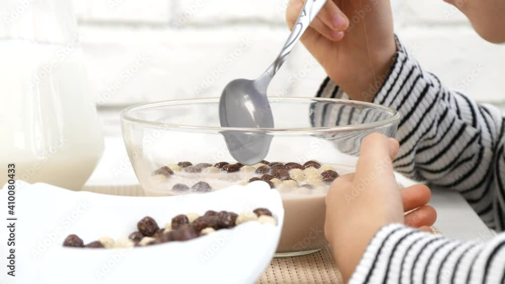 Kid Eating Milk and Cereals at Breakfast, Child in Kitchen, Blonde Teenager Girl Tasting Healthy Food at Meal, Children Nutrition Kid Eating Milk and Cereals at Breakfast, Child in Kitchen, Blonde Teenager Girl Tasting Healthy Food at Meal, Children Nutrition