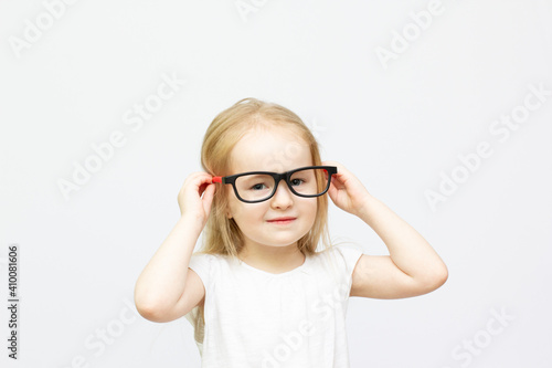 blond fashion kid girl with red and black glasses portrait isolated on white