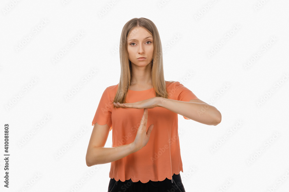 Fototapeta premium Young blond woman showing time out gesture. Human emotions, gesture concept. Studio shot, white background