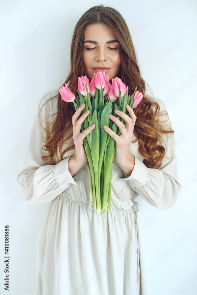Beautiful woman with tulips. Spring bouquet in the hands of a young and happy girl. High quality photo. - obrazy, fototapety, plakaty 