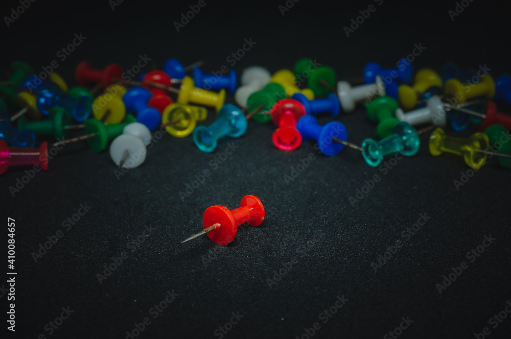 Push pins isolated black background, selective focus Push pins isolated black background, selective focus