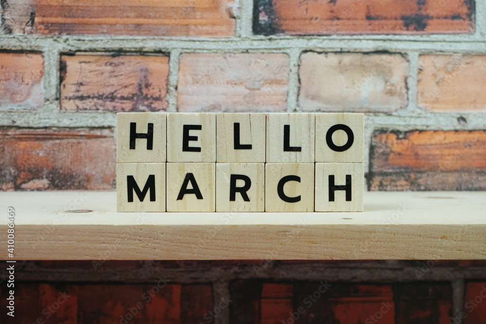 Obraz premium Hello March alphabet letter on shelves wooden background