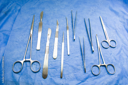 Top view of stainless steel dissecting kits on blue sterile table