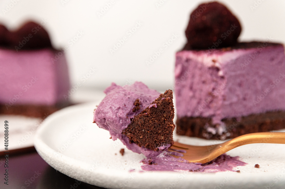 A piece of blueberry cheesecake on a white plate on the table. Exquisite party concept A piece of blueberry cheesecake on a white plate on the table. Exquisite party concept