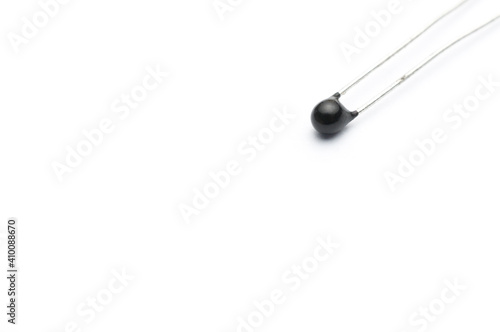 Close-up shot of an electronic thermistor isolated on white background photo