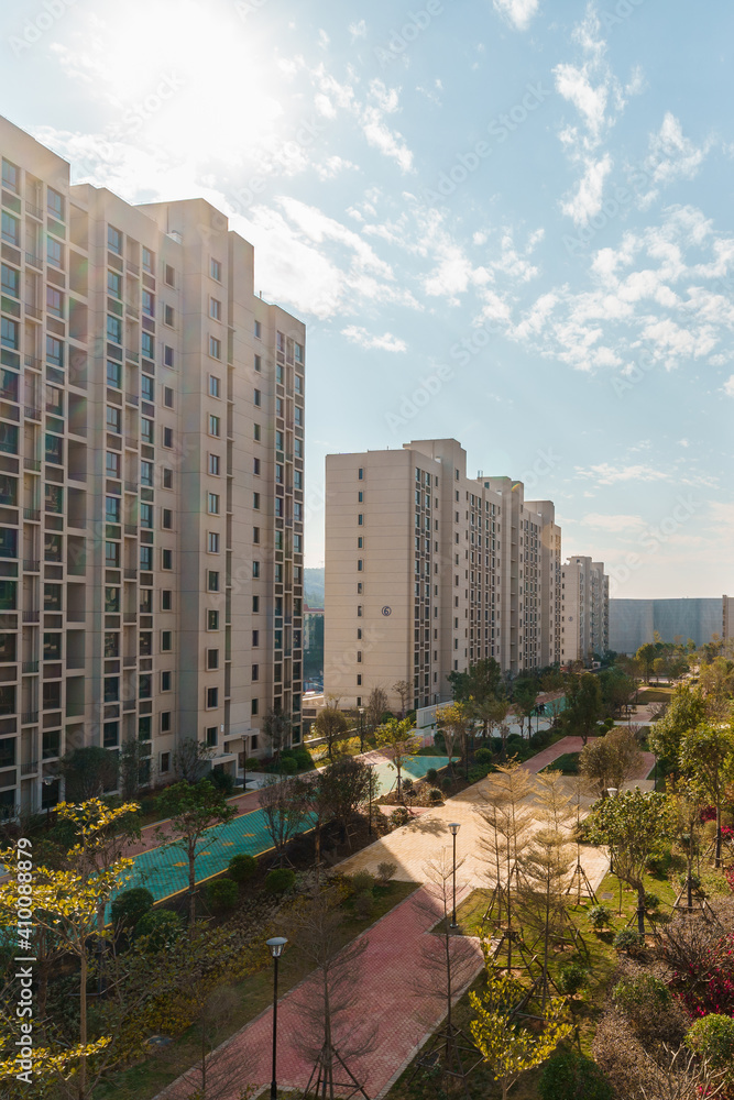 Modern urban living quarters, residential buildings and garden under the sunlight