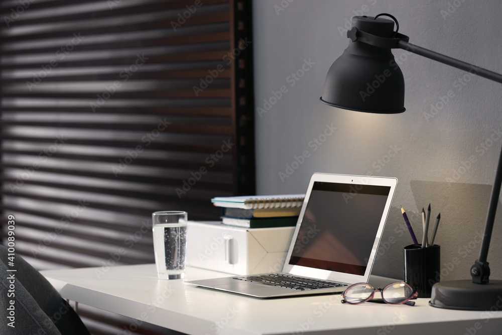Fototapeta premium Modern laptop and stationery on table in office