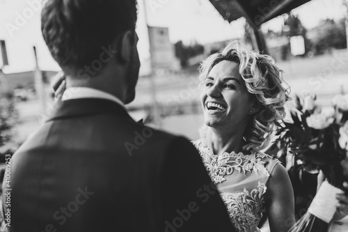 The bride and groom. Newlyweds standing on wedding ceremony outdoor. First meeting. Backyard. Black and white photo. © Serhii