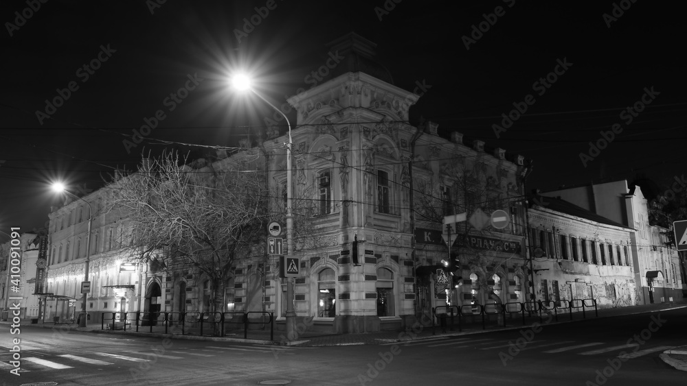 The facade of an old house at night. Street lights.
Urban architecture with artificial lighting
