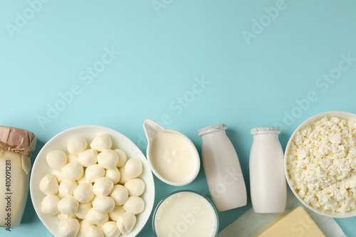 Photos Different fresh dairy products on blue background, space for text