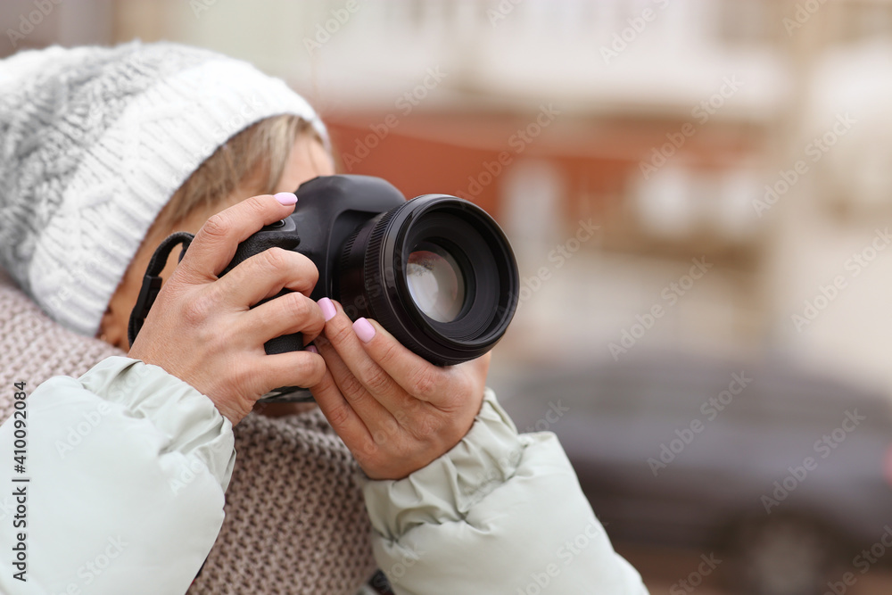 Photographer taking photo with professional camera outdoors