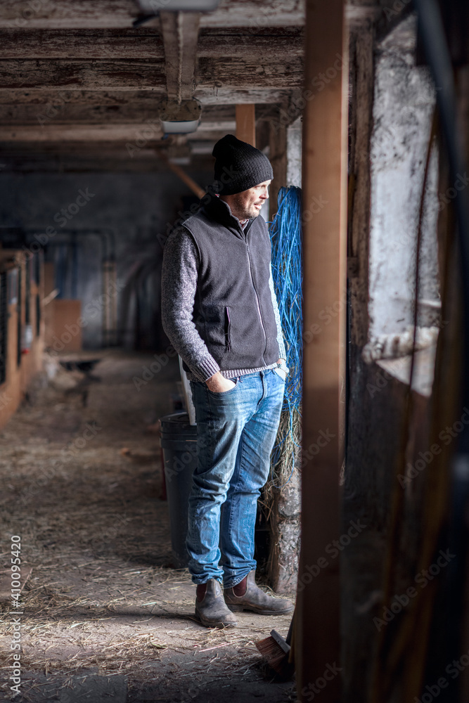 Man standing in stable Man standing in stable