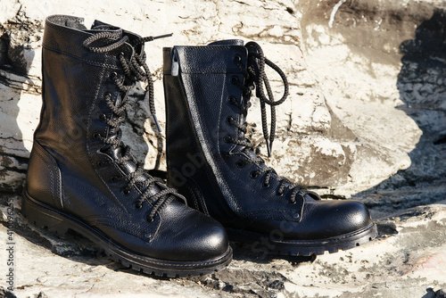 Unisex black boots with zipped laces on the street